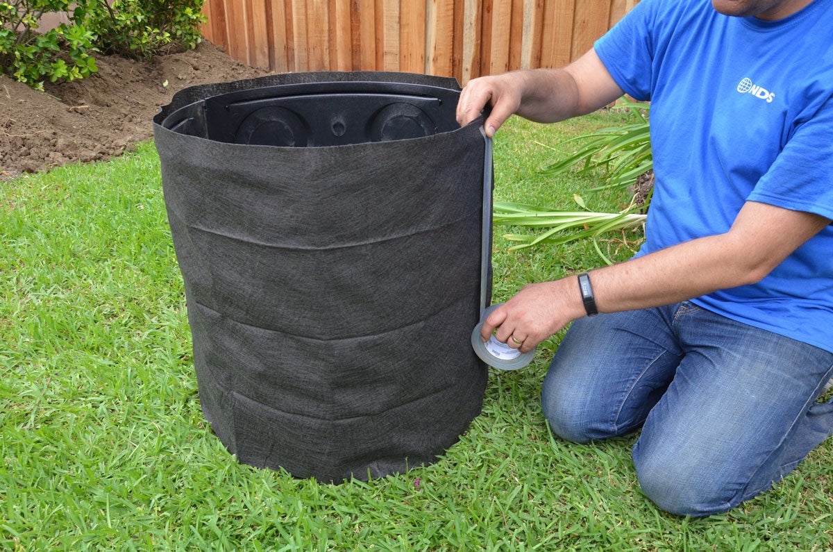 A dry well is an underground water management system that captures stormwater runoff and slowly releases it into the surrounding soil through natural infiltration. 